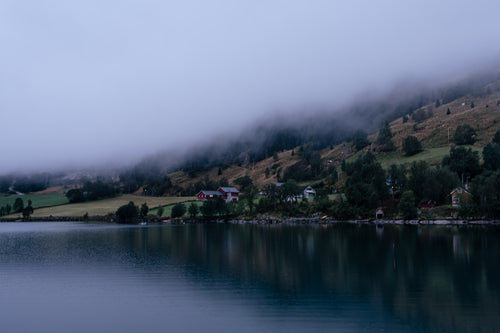 Fog draping over Norwegian hillside and village – Cloak fine art landscape print.